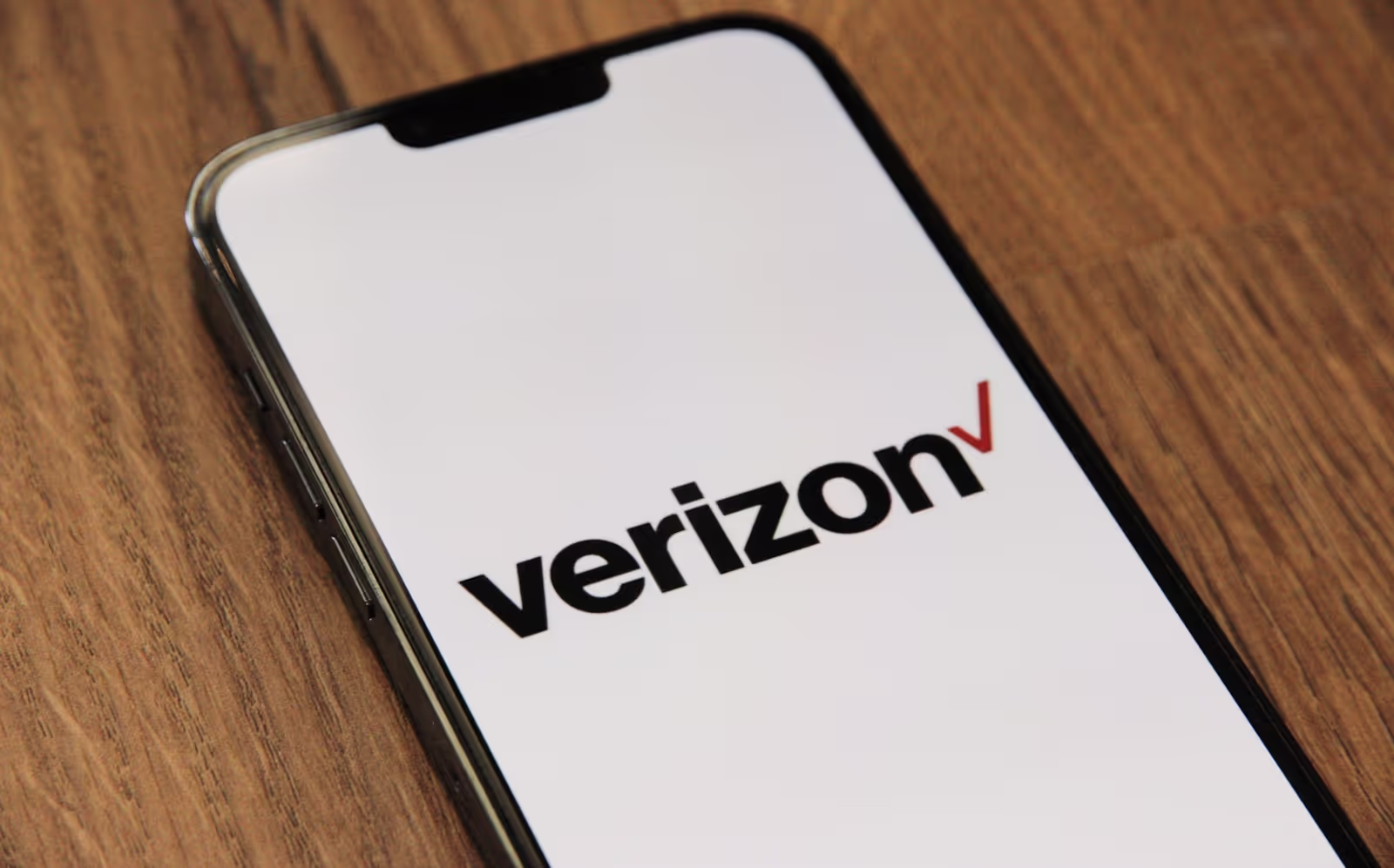 Happy person using a smartphone with Verizon logo