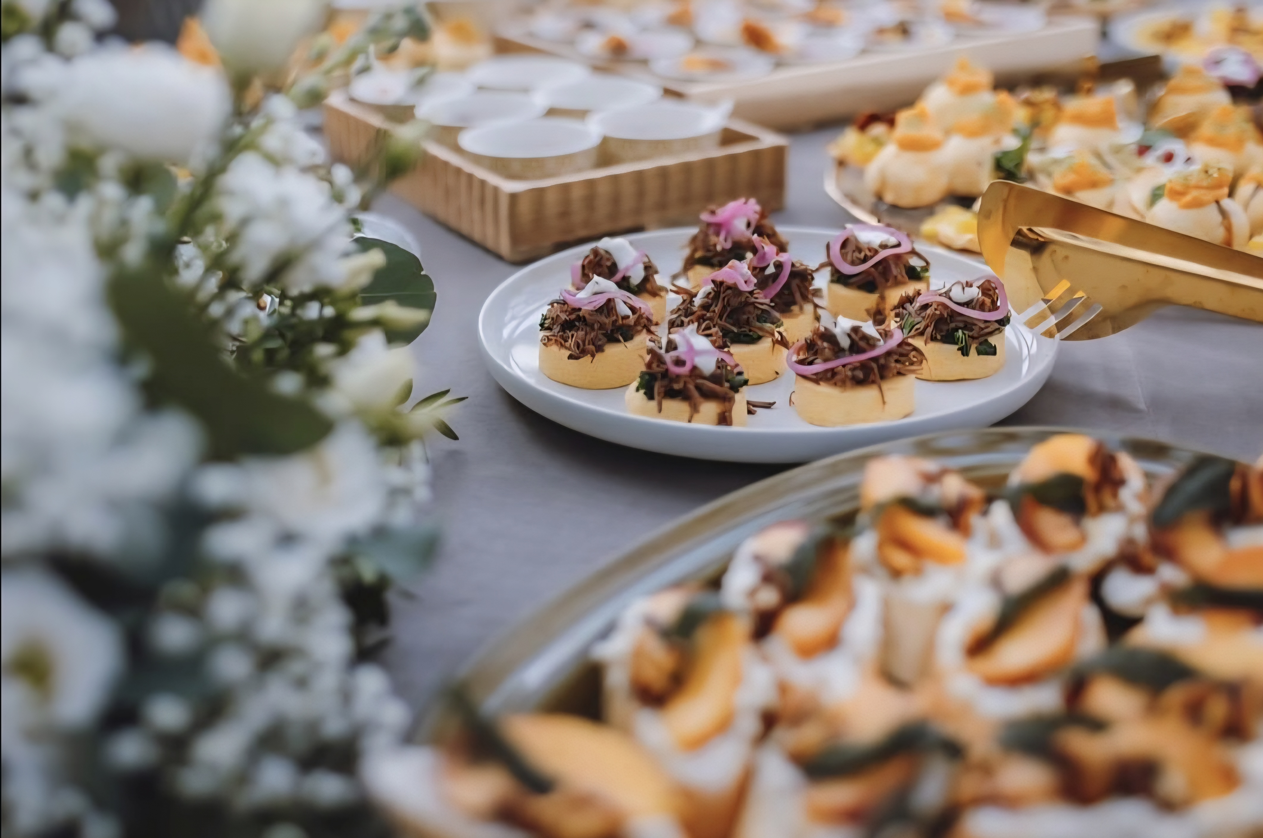 An elegant buffet table showcasing gourmet appetizers and fine dining presentation at a catered event.