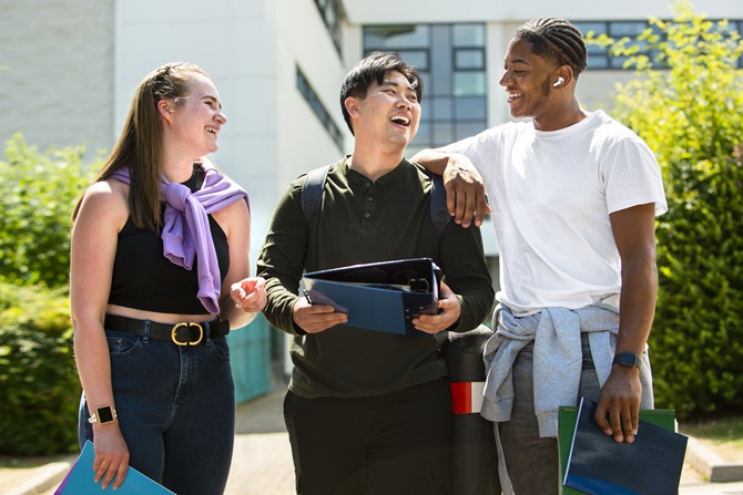 Student happily walking with new friends after applying College belonging tips that work.