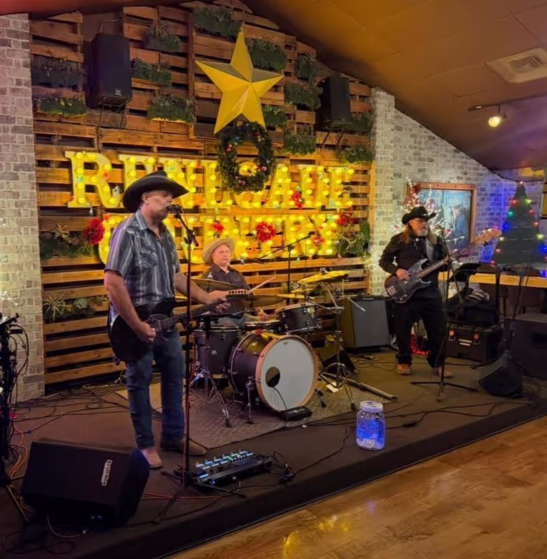 Big Sky Moon band members posing together, capturing their authentic Americana vibe and professional dynamic with instruments.