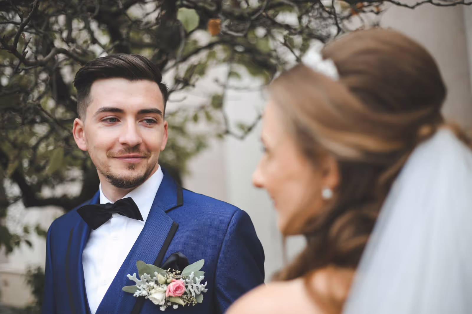 Elegant wedding couple sharing a candid moment outdoors
