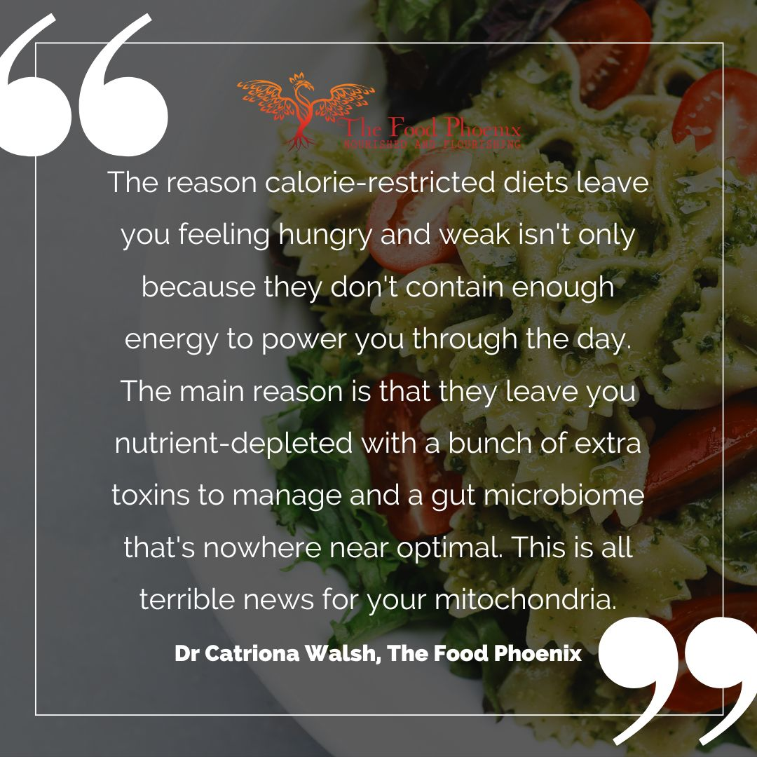 Quote graphic over a close-up of pesto bowtie pasta with cherry tomatoes. Large quotation marks and The Food Phoenix logo appear. The quote by Dr Catriona Walsh says calorie‑restricted diets not only lack energy but leave you nutrient‑depleted, burdened with toxins, and with a suboptimal gut microbiome—bad for mitochondria.