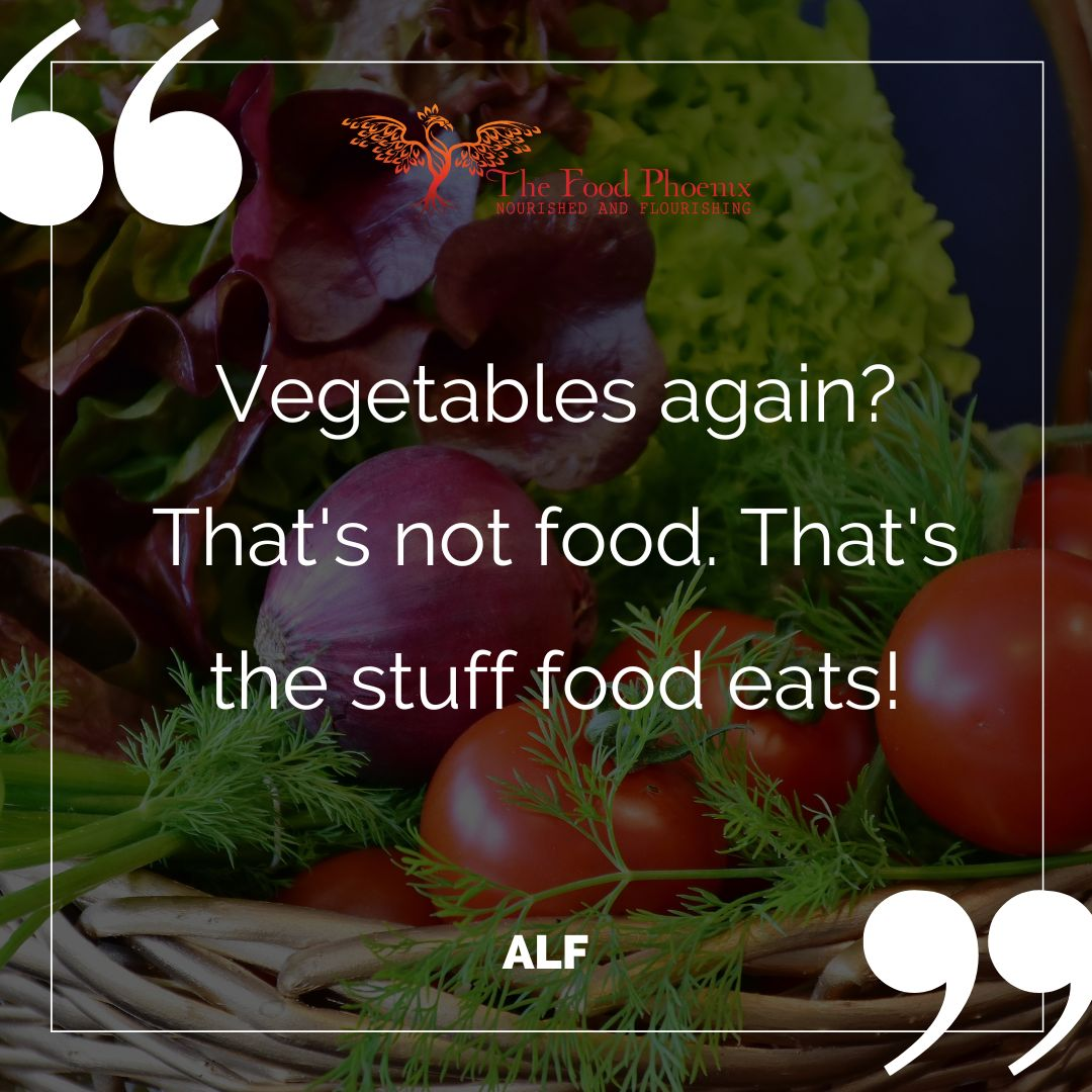 Photo of a wicker basket filled with tomatoes, red onion, leafy greens, and herbs, overlaid with the quote: Vegetables again? That's not food. That's the stuff food eats! - ALF. The Food Phoenix logo appears at the top with large quotation marks framing the design.