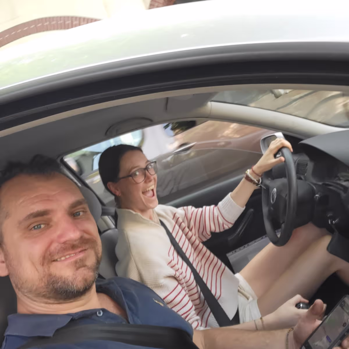 Konrad and Caro Driving in their VW Golf Konrad and Caro Driving in their VW Golf