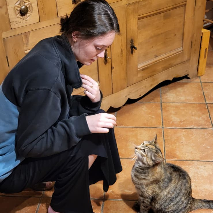 Caro feeding a cat while we were house sitting in France