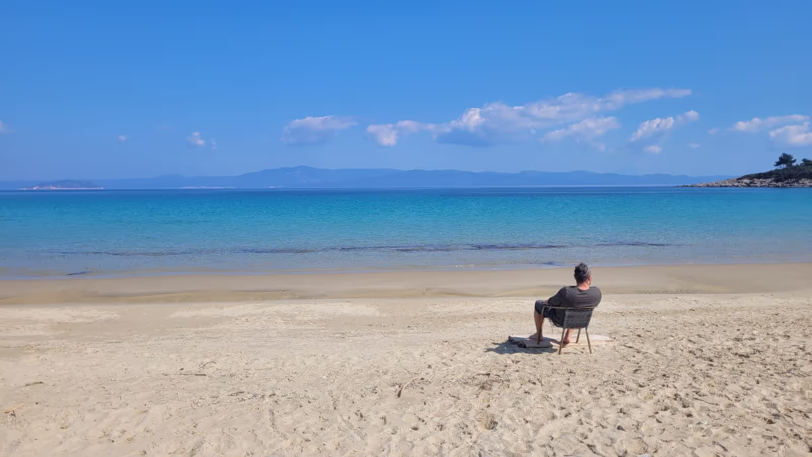 Konrad sitting on a beach in Greece Konrad sitting on a beach in Greece