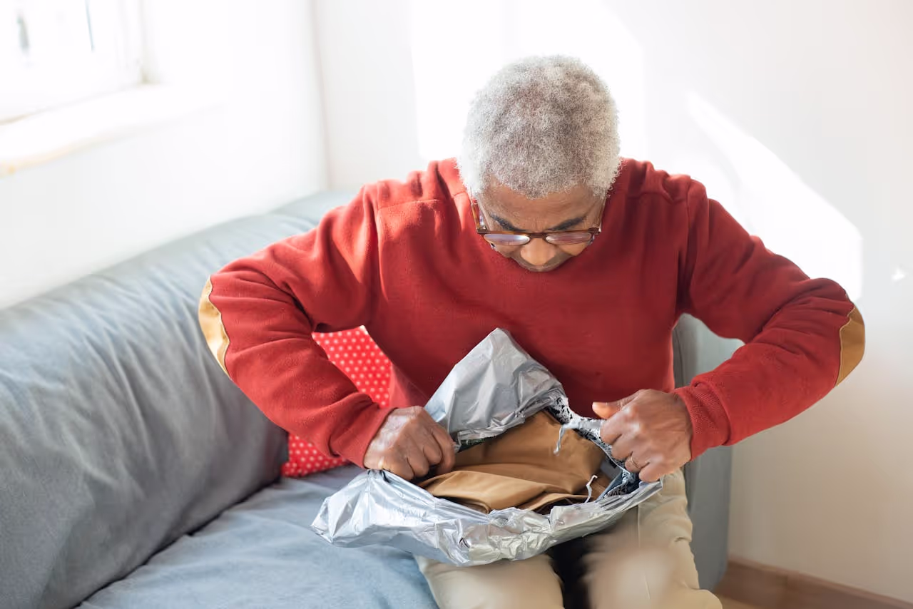 A person opening up a package A person opening up a package