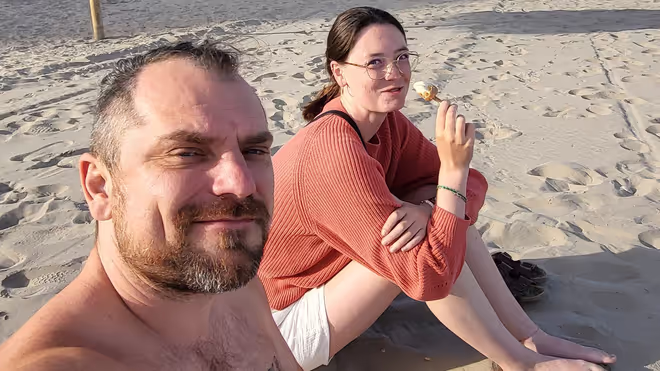 Konrad and Caro sitting at a beach in Spain Konrad and Caro sitting at a beach in Spain