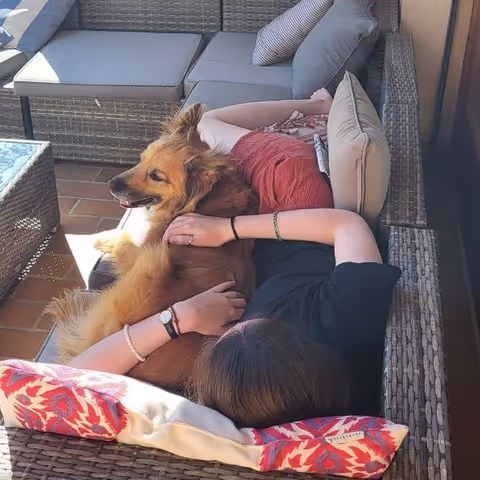Caro laying on the couch with the dog from france