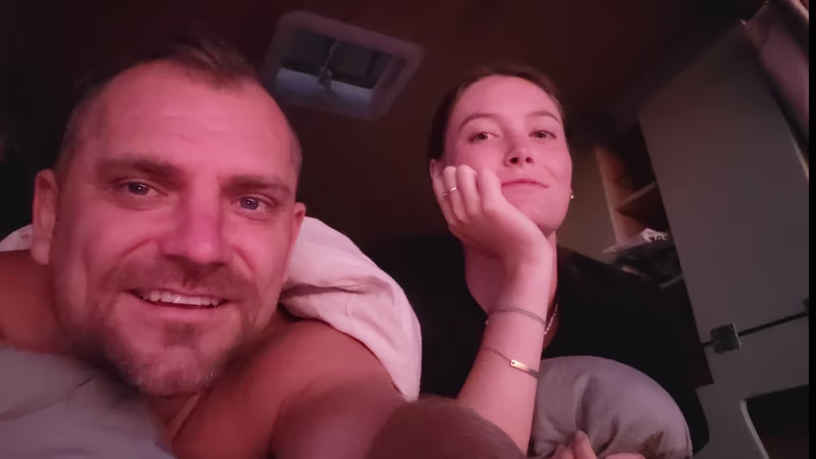 Konrad and Caro watching the sunset out of the back of their VW T4 van