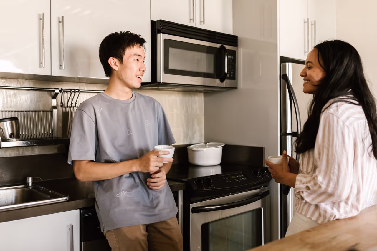 A house sitter having a conversation with the house owner A house sitter having a conversation with the house owner