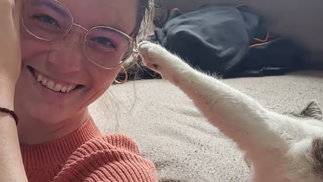 A cat trying to take Caro's glasses off her face during the house sit in France A cat trying to take Caro's glasses off her face during the house sit in France