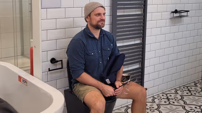 Konrad sitting on a toilet in the shops Konrad sitting on a toilet in the shops