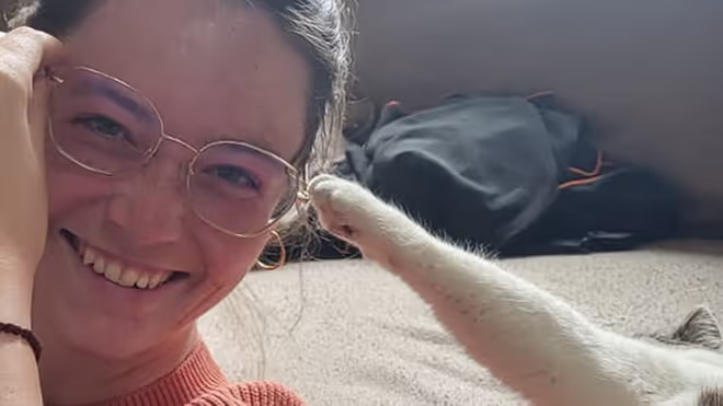 Cat trying to pull Caro's glasses off Cat trying to pull Caro's glasses off