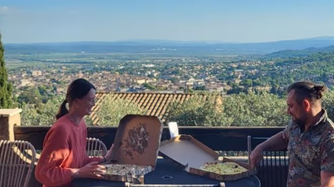 Konrad and Caro having a pizza during a house sit in France Konrad and Caro having a pizza during a house sit in France