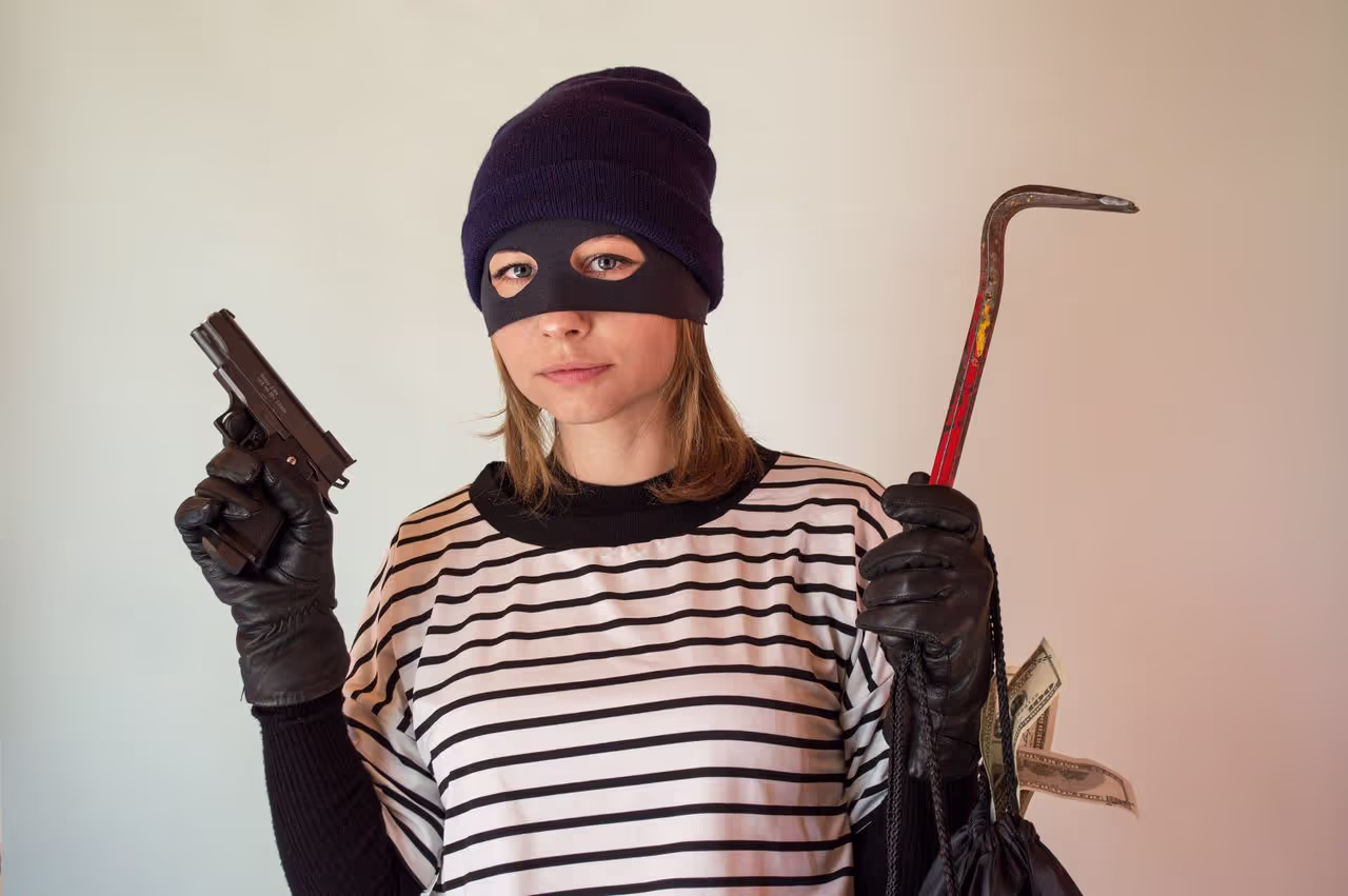 A thief ready to break into a home A thief ready to break into a home