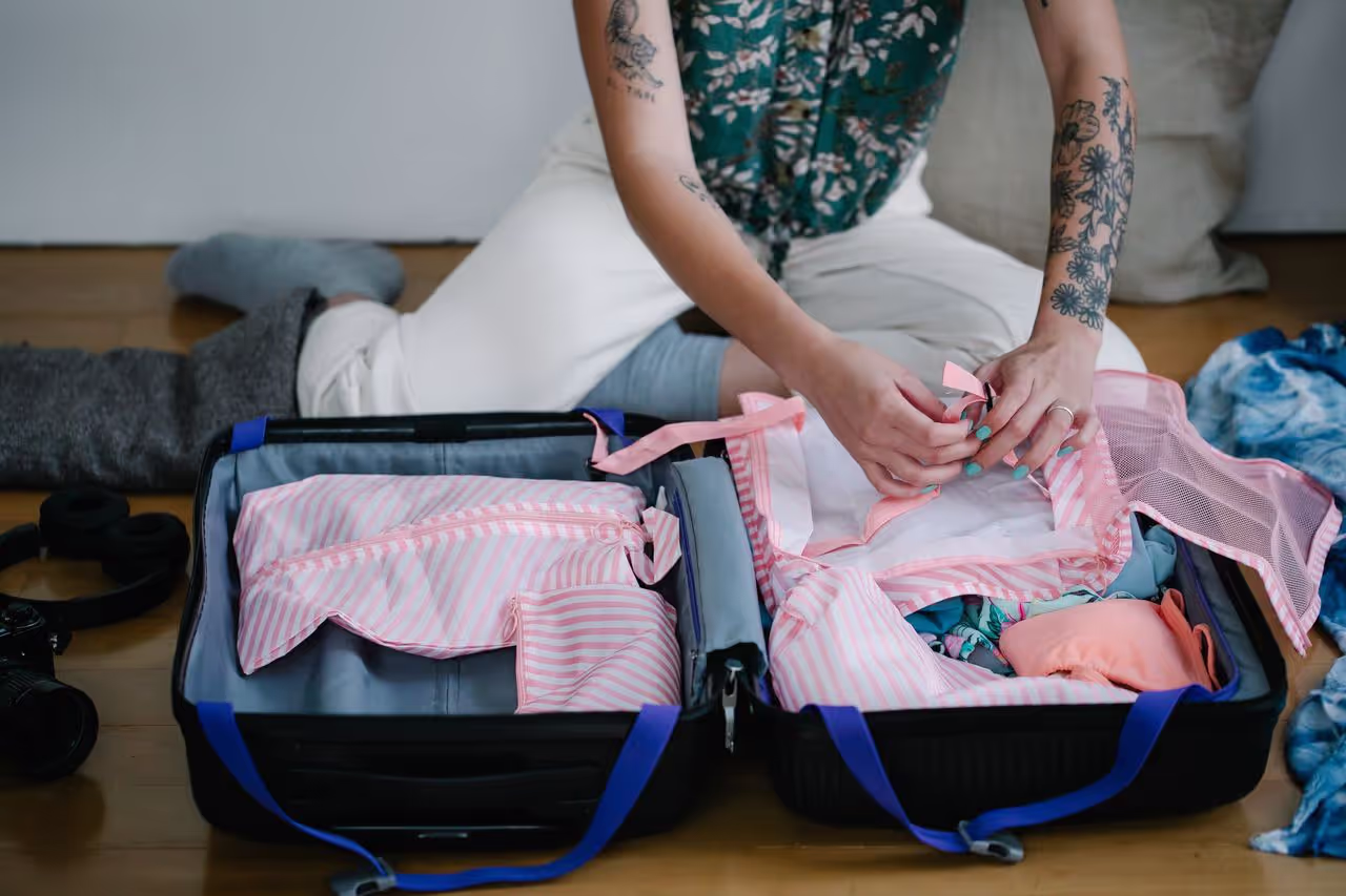 A woman packing her suitcase, getting ready for a house sit A woman packing her suitcase, getting ready for a house sit