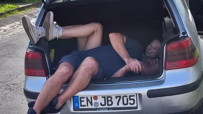Konrad and Caro in their old car