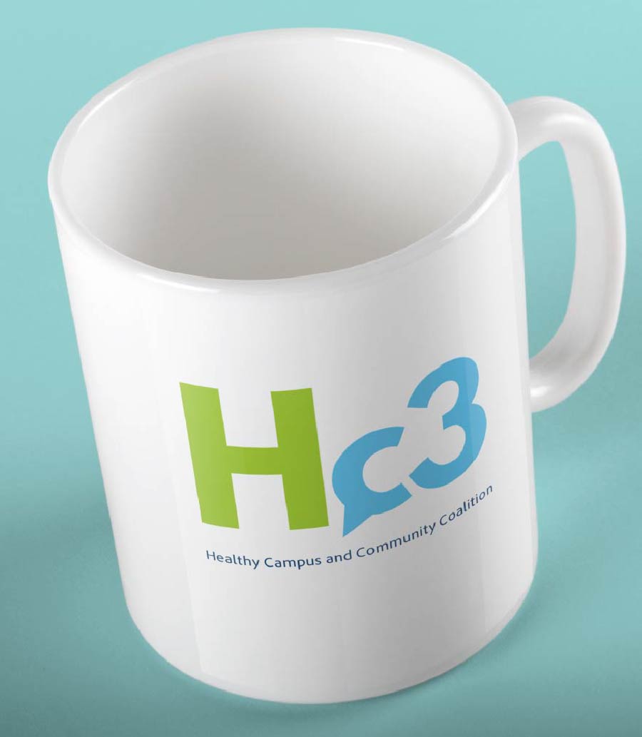 A white mug with a green 'H' and blue 'c3' logo, below which reads 'Healthy Campus and Community Coalition' in smaller text, all set against a light blue background.