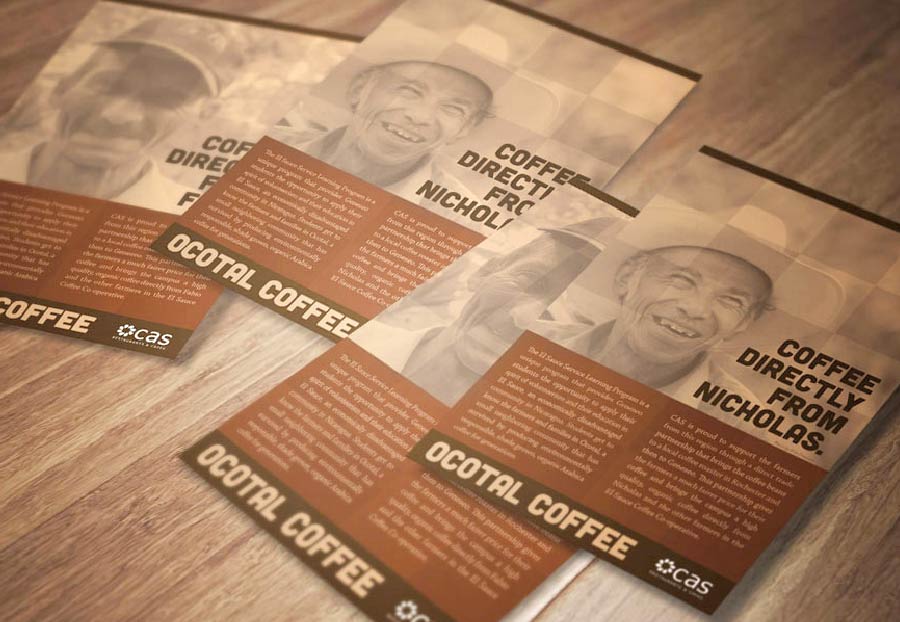 Multiple brown and white coffee flyers featuring a smiling man in a hat and text that reads 'OCOTAL COFFEE' and 'COFFEE DIRECTLY FROM NICHOLAS,' spread out on a light brown wooden surface.